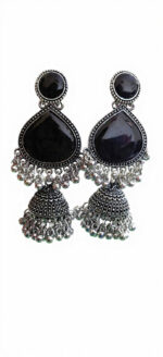 Woman wearing black stone silver jhumka earrings with intricate oxidised silver detailing