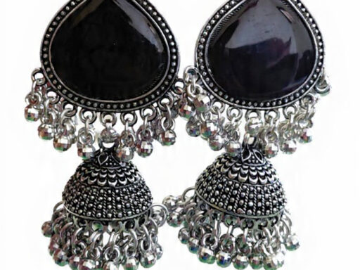Woman wearing black stone silver jhumka earrings with intricate oxidised silver detailing