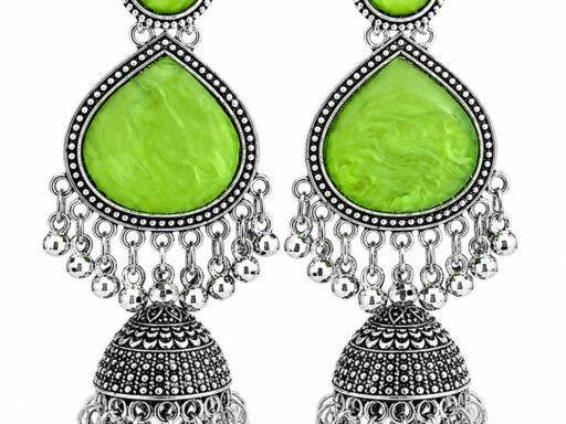 Woman wearing light green stone silver jhumka earrings with intricate oxidised silver detailing