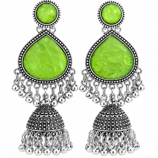 Woman wearing light green stone silver jhumka earrings with intricate oxidised silver detailing