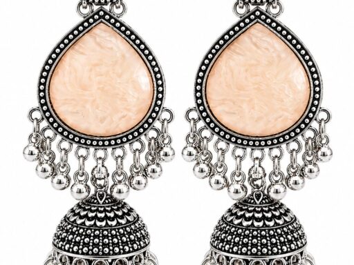 Woman wearing light peach stone silver jhumka earrings with intricate oxidised silver detailing
