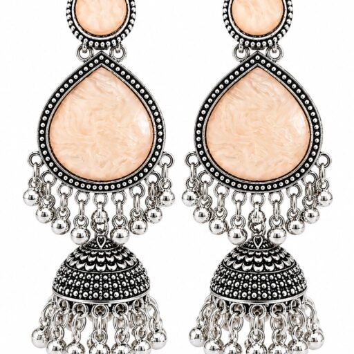 Woman wearing light peach stone silver jhumka earrings with intricate oxidised silver detailing