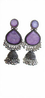Woman wearing purple stone silver jhumka earrings with intricate oxidised silver detailing