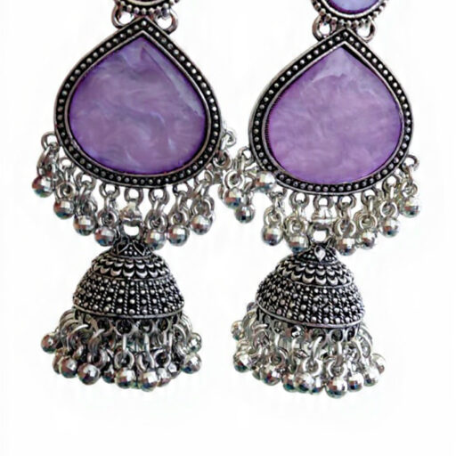 Woman wearing purple stone silver jhumka earrings with intricate oxidised silver detailing