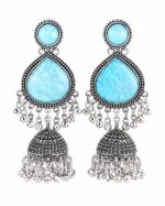 Woman wearing sky blue stone silver jhumka earrings with intricate oxidised silver detailing