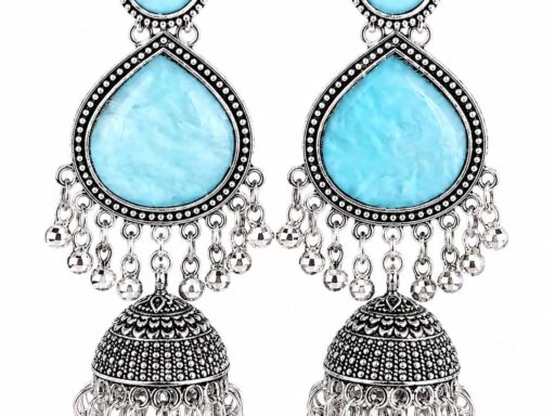 Woman wearing sky blue stone silver jhumka earrings with intricate oxidised silver detailing