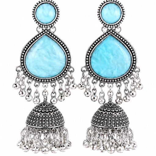 Woman wearing sky blue stone silver jhumka earrings with intricate oxidised silver detailing